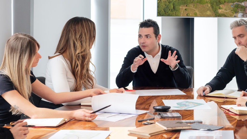 A professional team engaged in a serious business discussion in a minimalist office setting, discussing top reasons for planning permission refusal