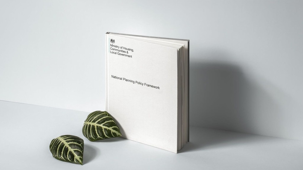 Minimalistic image of the National Planning Policy Framework book by the Ministry of Housing, Communities & Local Government, with decorative green leaves on a clean white surface.