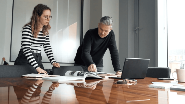 Image cover for the article: Close-up of hands of architects working on a blueprint with a ruler and a level, highlighting collaboration and precision in architectural planning.