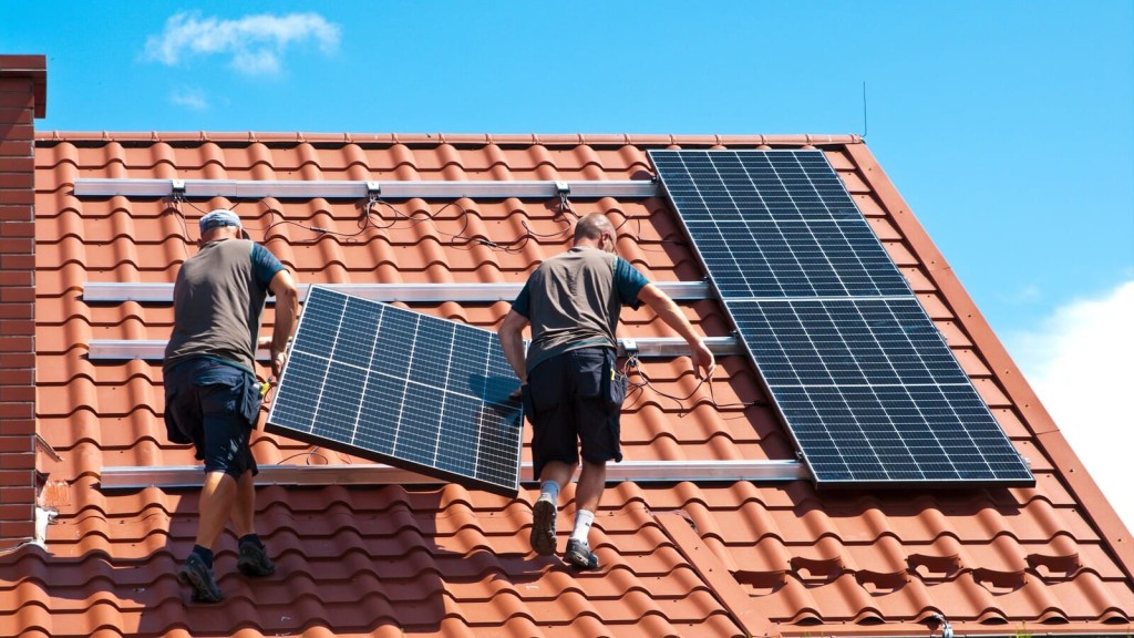 Workers install solar panels on a rooftop, reflecting sustainable growth and The Presumption in Favour of Sustainable Development within the Housing Delivery Test framework.
