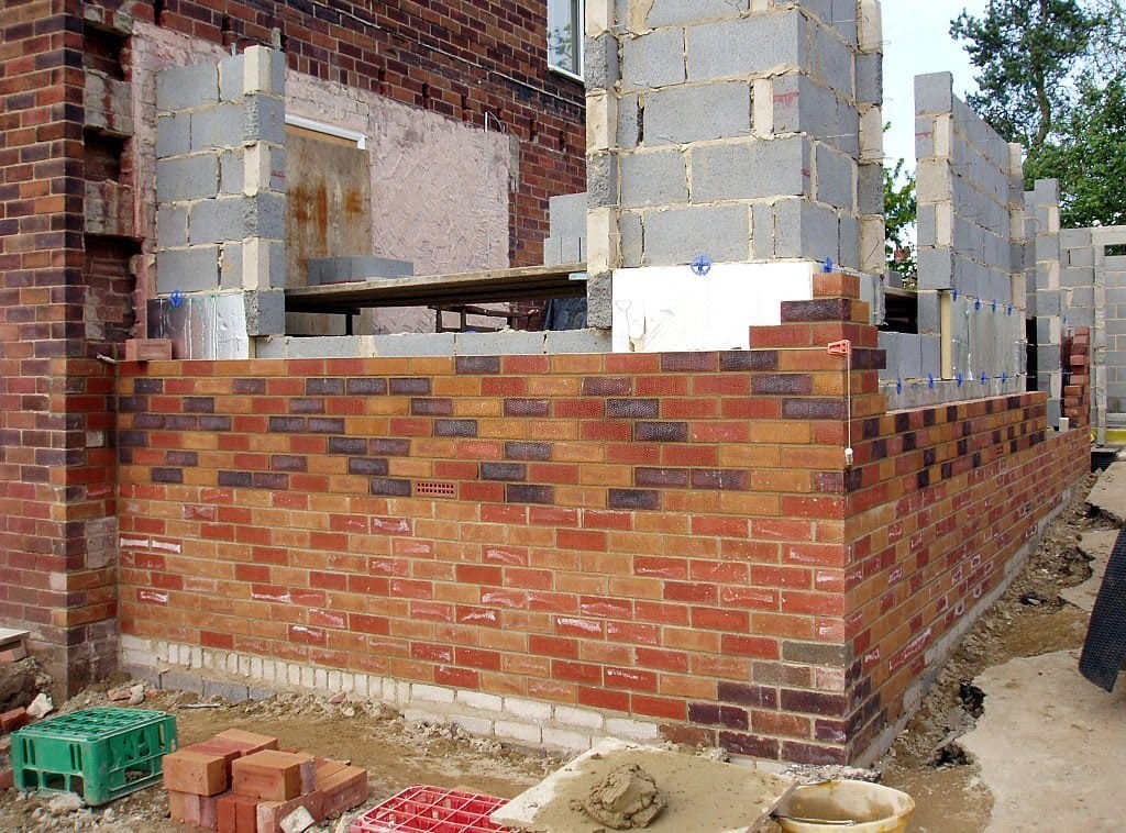 Side extension in the process of being built with red bricks matching the orginal property