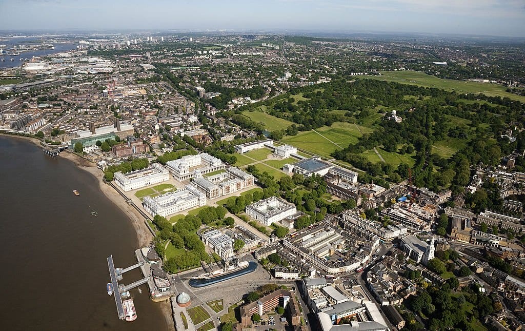 Aerial photograph of Greenwich on a sunny day overlooking the Naval College, the Queen's House and Greenwich Park with its observatory.  