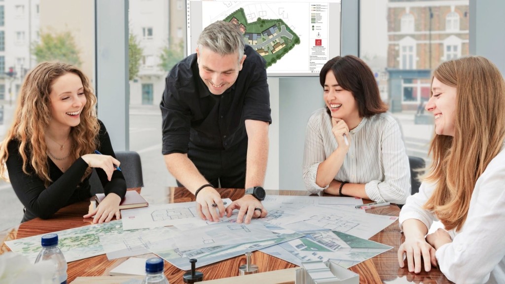 Team of architects and designers laughing and discussing over plans in a bright office, with architectural drawings and a 3D model on the table, symbolising collaborative work in urban architecture.