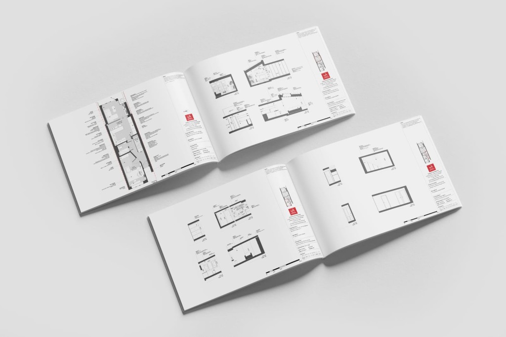 Two open landscape booklets with printed architectural layout plans for a large extension project including a basement level with its required labelling of materials and/or external consultant involvement
