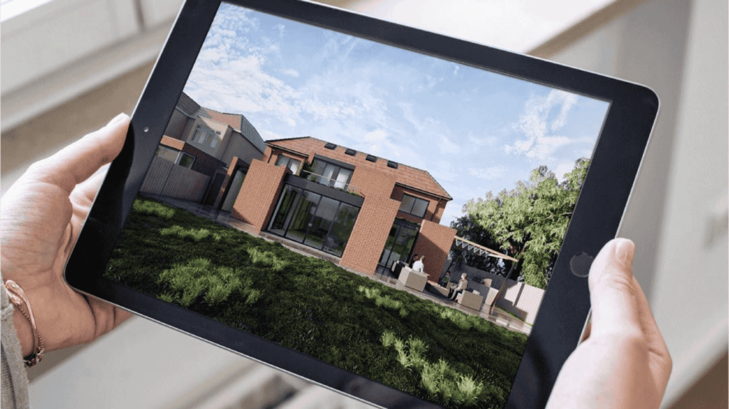 Person holding a tablet displaying a 3D architectural rendering of a modern brick house with large windows and a landscaped backyard, showcasing advanced digital technology in construction planning.