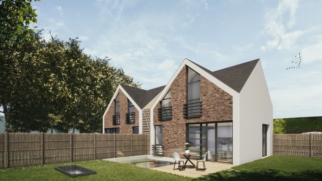 Modern gabled architecture of a new-build residential home featuring large windows, brick facade, and a manicured lawn with outdoor seating area.