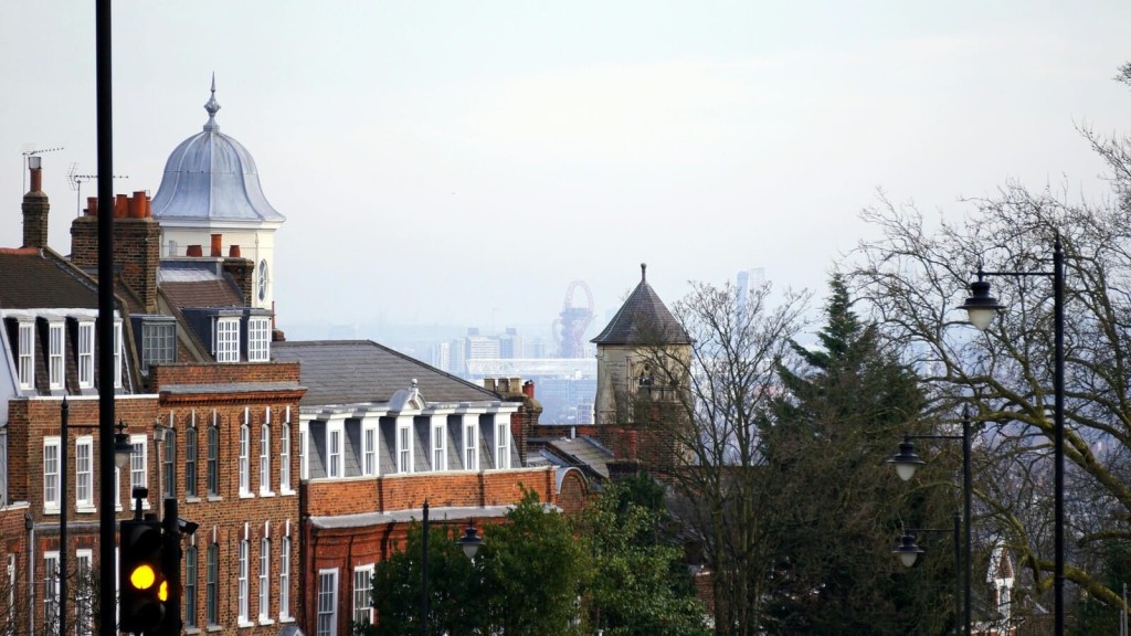 A cityscape featuring historic buildings that could benefit from retrofitting for energy efficiency, with a modern urban skyline visible in the background.