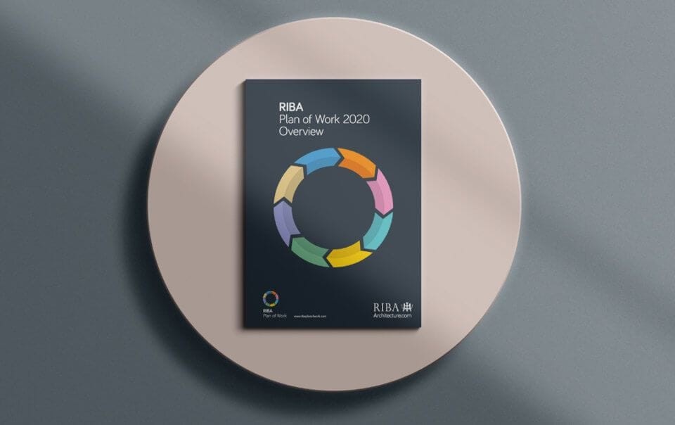 RIBA Plan of Work 2020 Overview booklet on a round table with a modern design, featuring a colorful circular graphic on the cover indicating various stages of architectural design and planning.