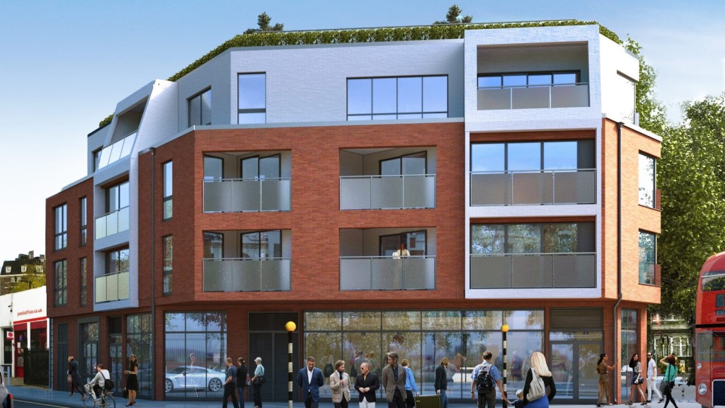 Modern mixed-use building with red brick and white facade, featuring residential units with balconies, retail space on the ground floor, and a green rooftop, situated in an urban street scene with pedestrians and a classic red London bus passing by.