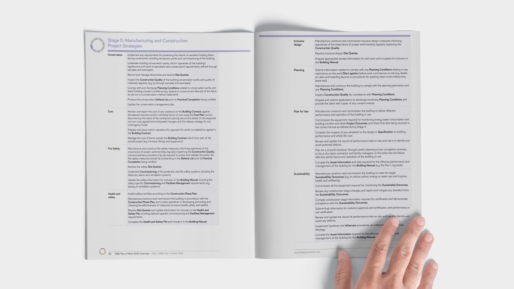 Hand turning a page in the RIBA Plan of Work 2020 guidebook, showing details of Stage 5: Manufacturing and Construction, outlining the strategic project considerations, tasks, and management processes in architectural and construction planning.