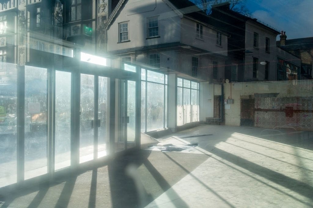 Interior of an empty commercial space with large windows, showcasing the potential for conversion from Class E commercial use to Class C3 residential under new permitted development rights in England.