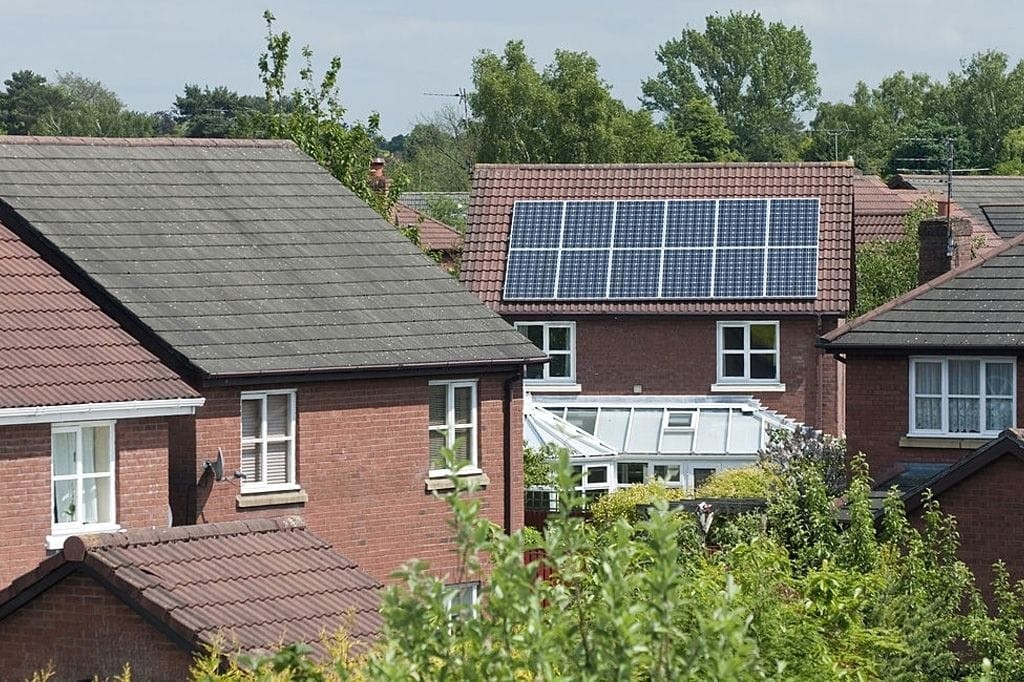 UK suburban homes with solar panels installed on rooftops, showcasing sustainable energy solutions for residential renovation and design.