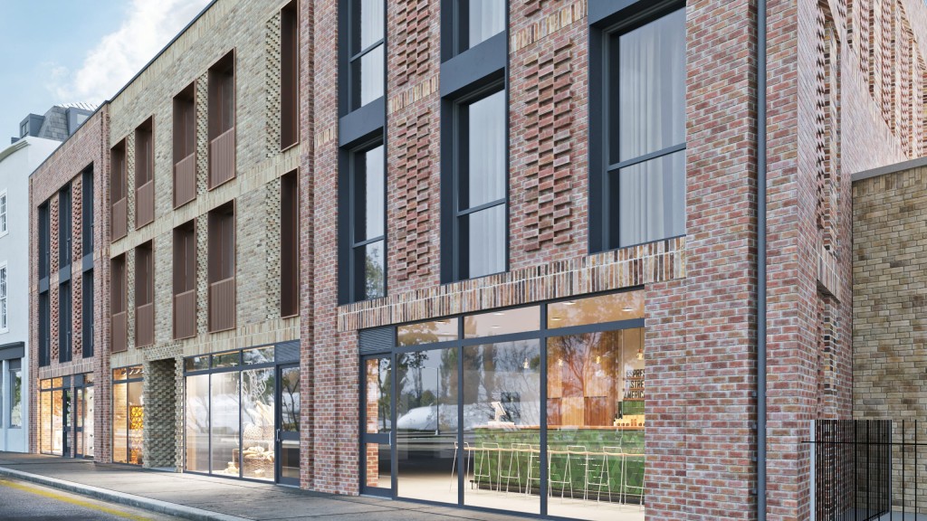 Contemporary urban building facade with a blend of brickwork and large glass windows, reflecting modern architectural design in London.