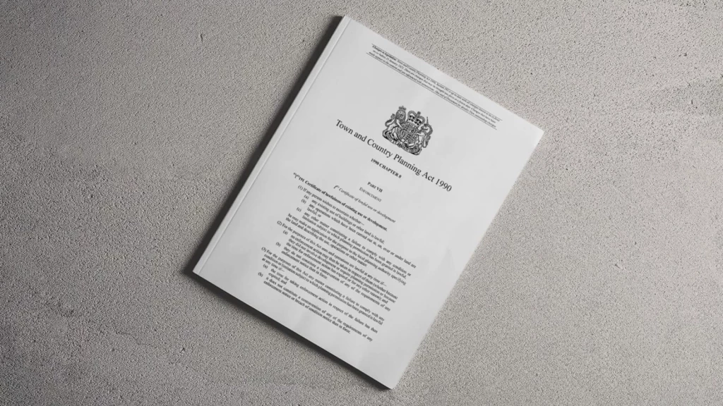 A printed copy of the Town and Country Planning Act 1990, which defines legal frameworks including the four-year rule and ten-year rule for planning enforcement in England.