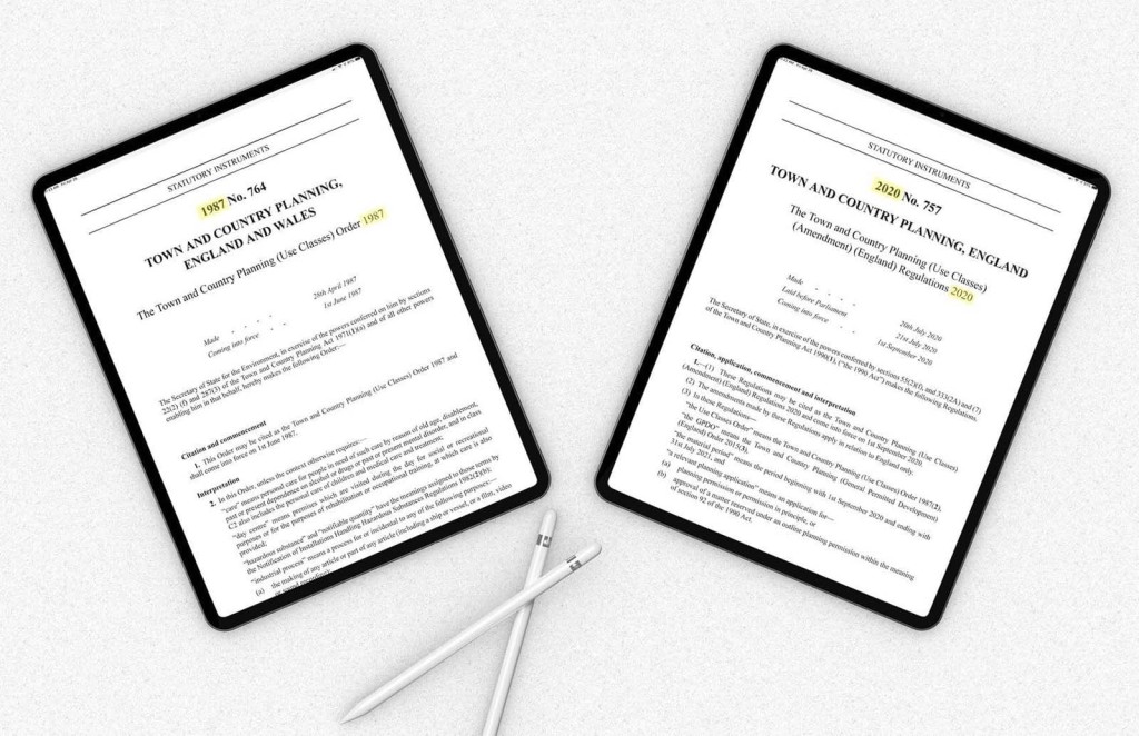 Two tablets displaying official documents of UK Town and Country Planning regulations, with one showing the Use Classes Order 1987 and the other the Amendment Regulations 2020, alongside a pair of Apple Pencils, signifying modern legal planning resources.