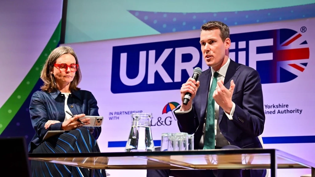 Housing Minister speaking at UKREiiF conference on planning reform, housing delivery and housebuilding policy in England during a panel discussion.