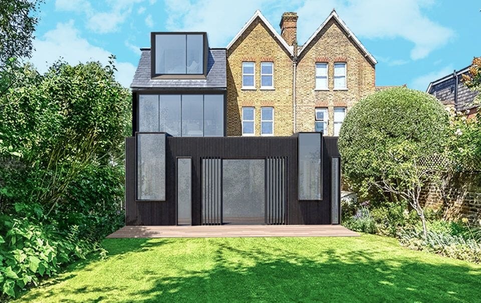 Contemporary wraparound extension on a Victorian house, featuring dark vertical cladding and large glass windows, harmoniously integrating modern design into the traditional architecture, set against a well-kept garden with lush greenery.