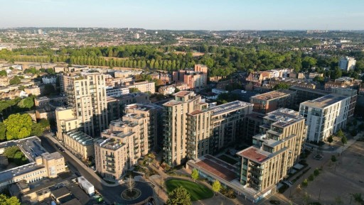 Aerial view of a densely developed area of Hackney with high rise flat developments varying from three floors and up to fourteen floors with plenty of green amenity space, cycle storage and parking