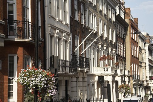 Side view of a typical street in Mayfair with each building having different styles in windows and balconies as well as materials and bricks