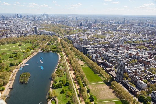 Aerial view of Westminster, London showcasing the contrast between high rise concrete jungle and green parks and blue lakes