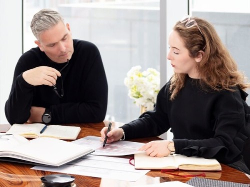 Architects reviewing design plans at a desk, representing architects’ professional wish lists and industry priorities for Christmas 2025, as featured in the RIBA architects wish list article.