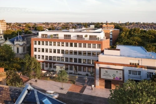 Aerial view of a converted office building in London now repurposed as residential flats, surrounded by trees and adjacent buildings. Ufuk Bahar gave an interview for a piece on office-to-homes conversions, highlighting the growing appeal of such developments following the shift to home-working and relaxed planning rules, despite technical hurdles.