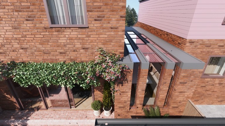 Aerial view of a house extension with a modern glass roof, climbing plants over a pergola, and a brick facade, showcasing contemporary residential architecture design.