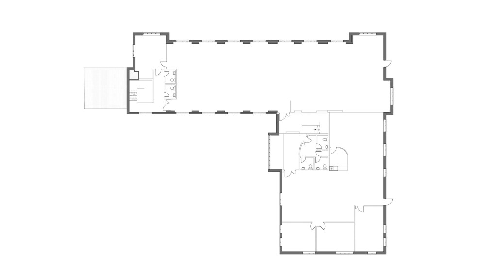 Existing first-floor plan of an office building, prior to its conversion into a residential home. The layout shows open office spaces, restrooms, and corridor areas typical of commercial office use. This design represents the original layout before the internal reconfiguration for its transformation into a luxury countryside residence. The project, located in Leamington Spa, follows Class MA guidelines, which restrict external modifications while allowing significant internal changes to accommodate modern family living. This floor plan is part of an office-to-house conversion project in collaboration with Warwick District Council.