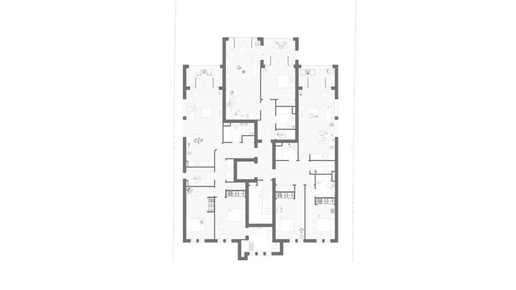 Detailed architectural blueprint of the first-floor plan for a multi-unit residential building, indicating the precise layout of rooms, furniture placement, and interior structure with labeled living areas, bedrooms, and facilities.