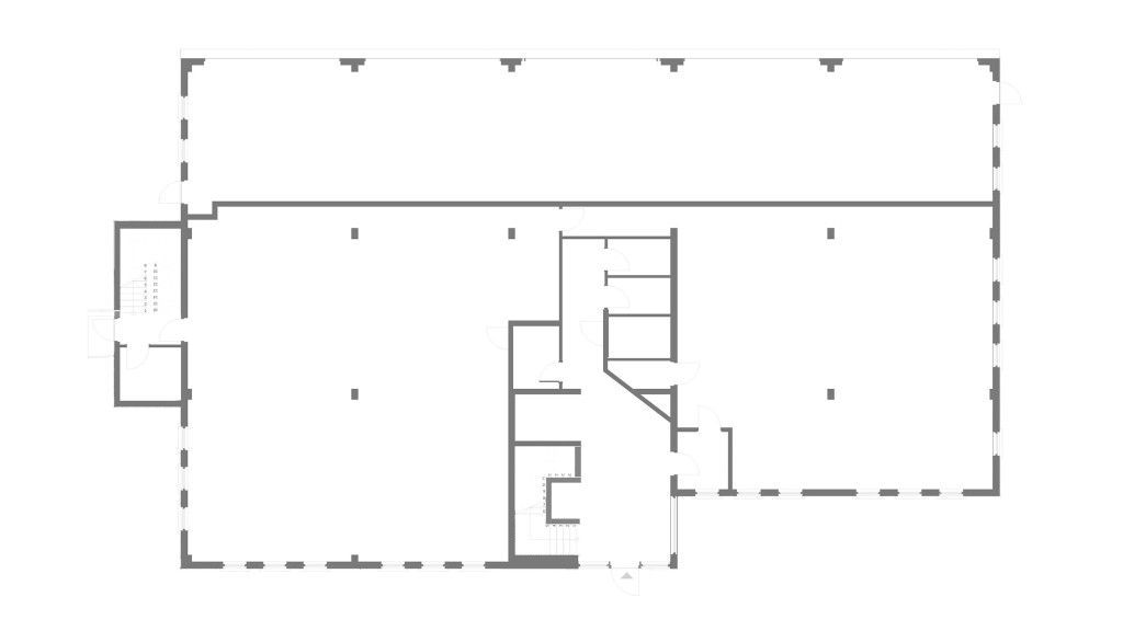 Existing ground floor plan of Paxton House in Swindon, showcasing the layout before the office-to-residential conversion by Urbanist Architecture. The floor plan features an open layout with structural elements and partitioned sections, highlighting the potential for transformation into stylish residential flats. This diagram is crucial for understanding the spatial arrangement and structural framework prior to the renovation, providing a baseline for the innovative redesign into modern, comfortable living spaces.