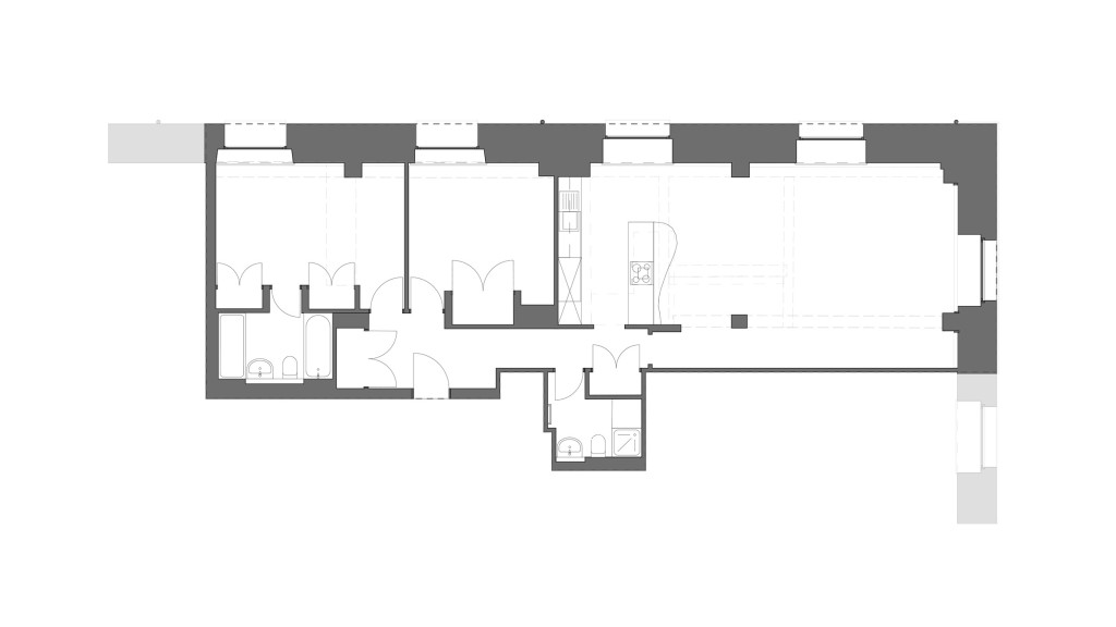 Existing floor plan of a flat in a Grade II-listed gunpowder warehouse conversion on The Highway E1W. The layout features a spacious open living area, separate bedrooms, and well-defined bathroom spaces. The historic structure's unique architectural elements are preserved, showcasing the building's original character. This floor plan highlights the initial configuration before the planned interior refurbishment by Urbanist Architecture, aimed at enhancing both functionality and aesthetics while respecting the building's heritage.