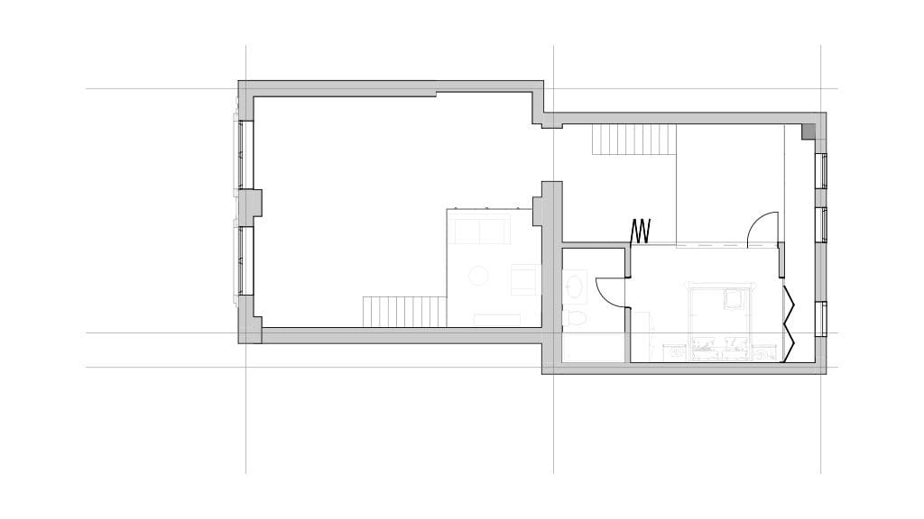 Architectural floor plan of the mezzanine level in a renovated Grade II-listed apartment, showing the layout of a bedroom, bathroom, and open living area. The design highlights efficient space utilisation and modern architectural elements within a historically significant structure.