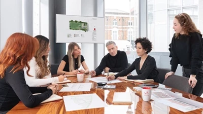 Residential architects and planning consultants discussing architectural drawings for a residential project