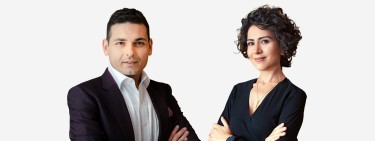 Portrait of Ufuk Bahar and Nicole I. Guler, renowned planning and design experts specialising in Green Belt developments, posing confidently. Ufuk Bahar is wearing a dark blazer, while Nicole I. Guler is dressed in a sleek black top, both exuding professionalism and expertise. This image highlights the authors of the book 'Green Light to Green Belt Developments,' a guide to navigating planning permissions and developments in Green Belt areas.